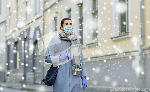 Image of young woman wearing protective medical mask