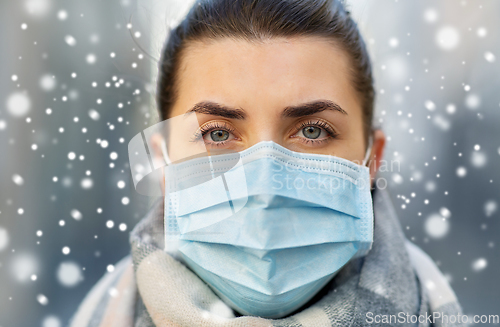 Image of young woman wearing protective medical mask