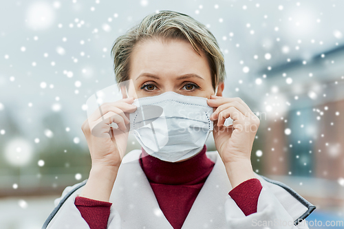 Image of young woman wearing protective medical mask