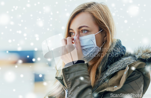 Image of young woman wearing protective medical mask