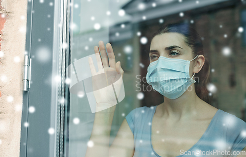 Image of sick young woman wearing protective medical mask