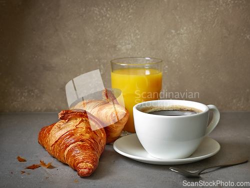 Image of cup of coffee and croissants