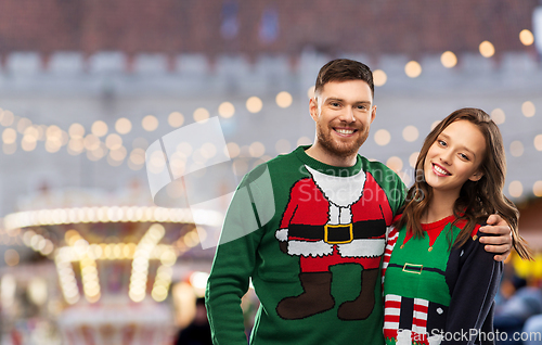 Image of happy couple at christmas ugly sweater party