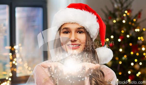 Image of teenage girl with magical fairy dust on christmas