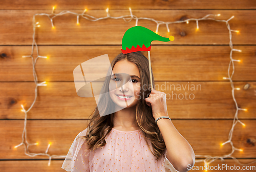 Image of happy teenage girl with santa helper hat accessory