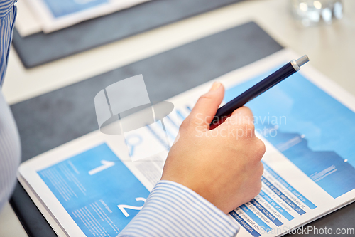 Image of close up of businessman with papers at office