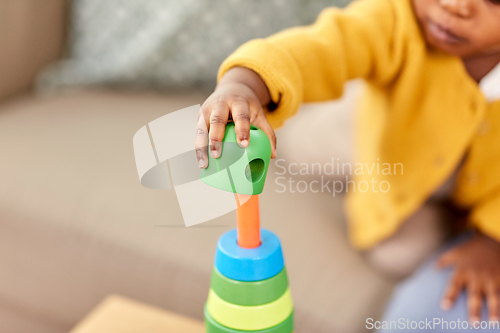 Image of close up of african baby playing toy blocks