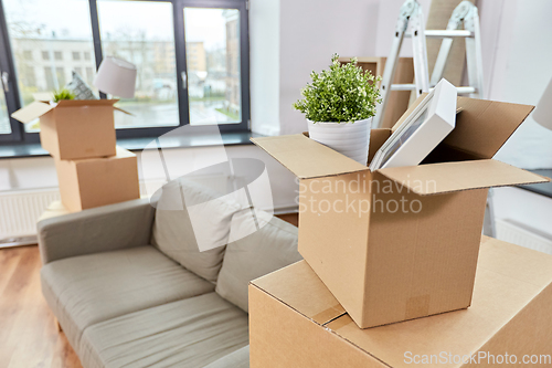 Image of sofa and corrugated boxes with stuff at new home