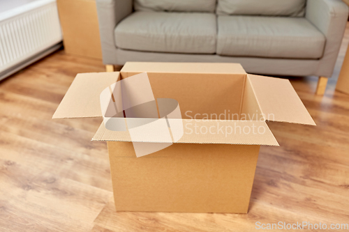 Image of empty corrugated box and sofa at new home