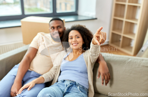 Image of happy couple with boxes moving to new home