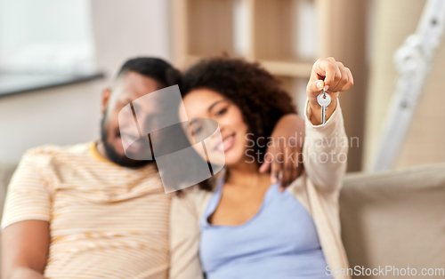 Image of happy couple with house key moving to new home