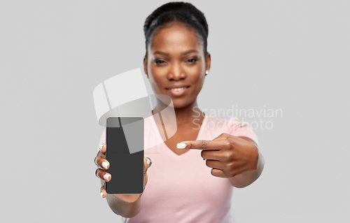Image of happy african american woman showing smartphone