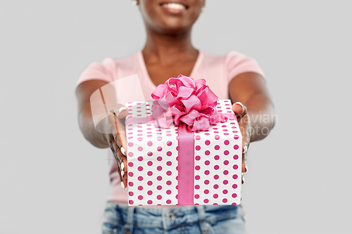 Image of close up of african american woman with gift box