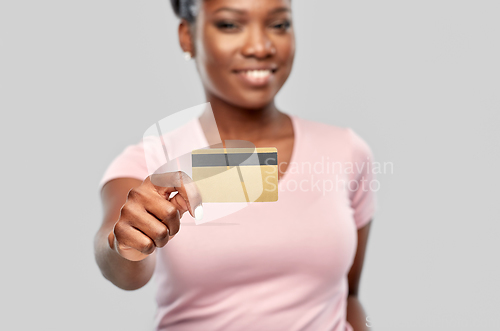 Image of happy african american woman with credit card