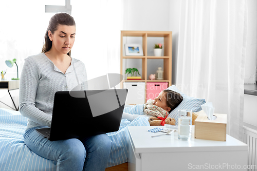 Image of ill daughter and mother with laptop at home