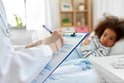 Image of doctor with clipboard and sick girl in bed at home