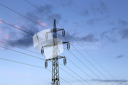 Image of High voltage tower against the evening cloudy sky