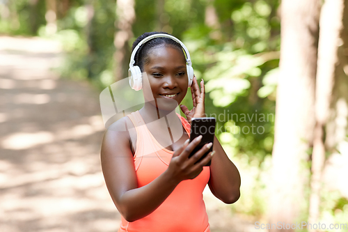 Image of african american woman with headphones and phone