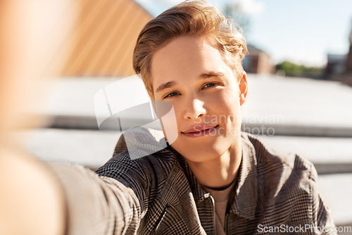 Image of young man or teenage boy taking selfie in city