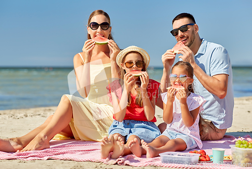 Image of happy family having picnic on summer beach