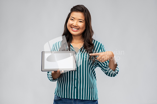 Image of happy asian woman using tablet computer