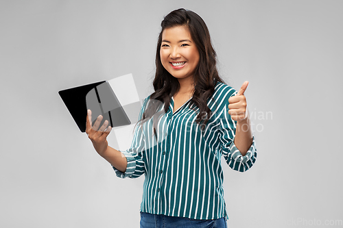 Image of happy asian woman with tablet pc showing thumbs up