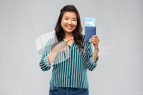 Image of happy asian woman with air ticket and passport