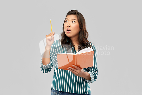 Image of asian student woman with diary and pencil