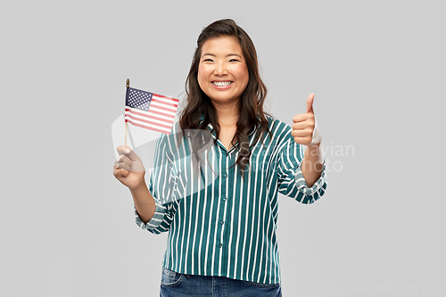 Image of asian woman with flag of america showing thumbs up