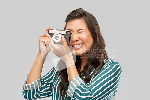 Image of asian female photographer with digital camera