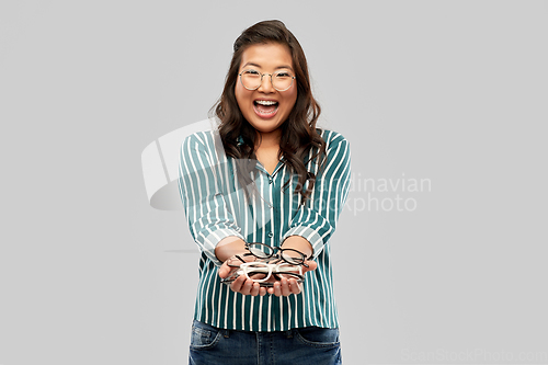 Image of happy smiling asian woman in glasses or student