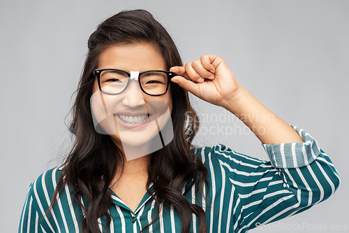 Image of portrait of happy asian woman in glasses