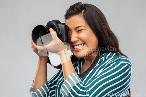 Image of asian female photographer with digital camera