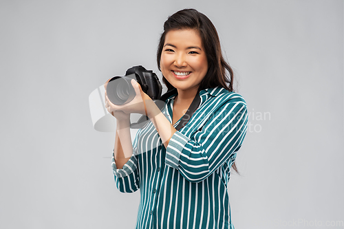 Image of asian female photographer with digital camera