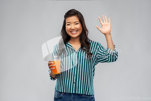 Image of asian woman with juice in plastic cup with straw