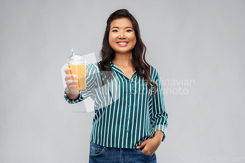 Image of asian woman with juice in plastic cup with straw