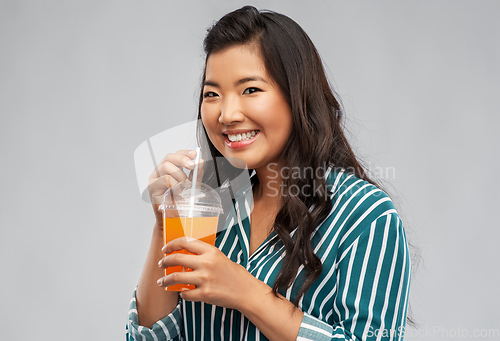 Image of asian woman with juice in plastic cup with straw