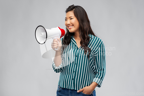 Image of happy smiling asian woman speaking to megaphone