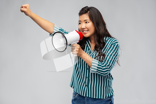 Image of happy smiling asian woman speaking to megaphone