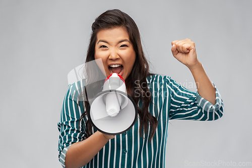 Image of angry young asian woman speaking to megaphone