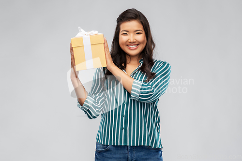 Image of happy asian woman with birthday present