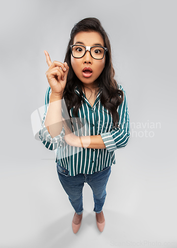 Image of surprised asian student woman pointing finger up