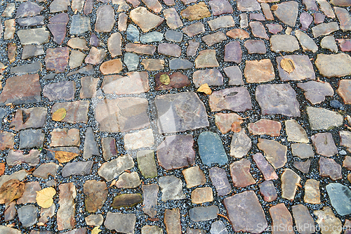 Image of Old pavement of stones of different colors and sizes 