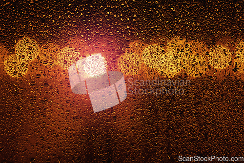 Image of Rain on a window with big city bokeh lights