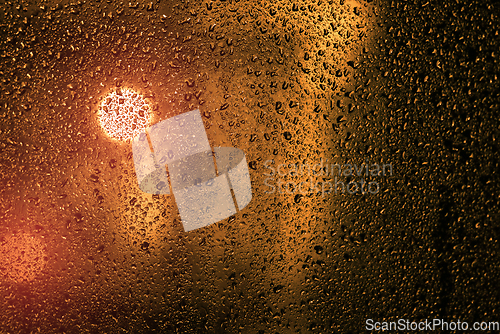 Image of Water droplets on a window with city lights