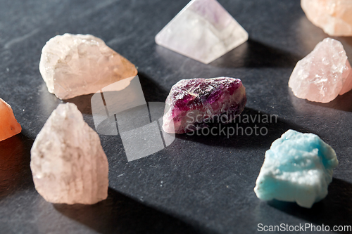 Image of quartz crystals and gem stones on slate background