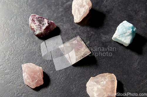 Image of quartz crystal pyramid and gem stones on slate