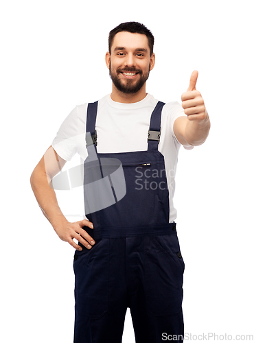 Image of smiling male worker or builder showing thumbs up