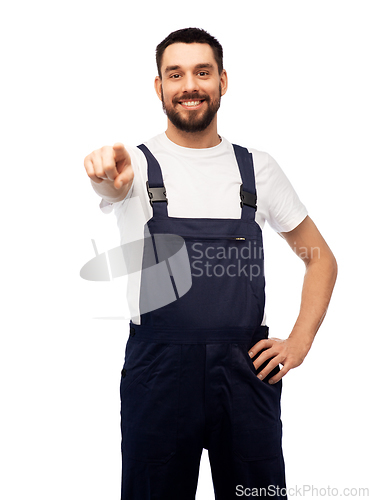 Image of smiling male worker or builder pointing to camera