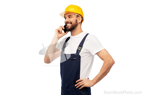 Image of happy male worker or builder calling on smartphone